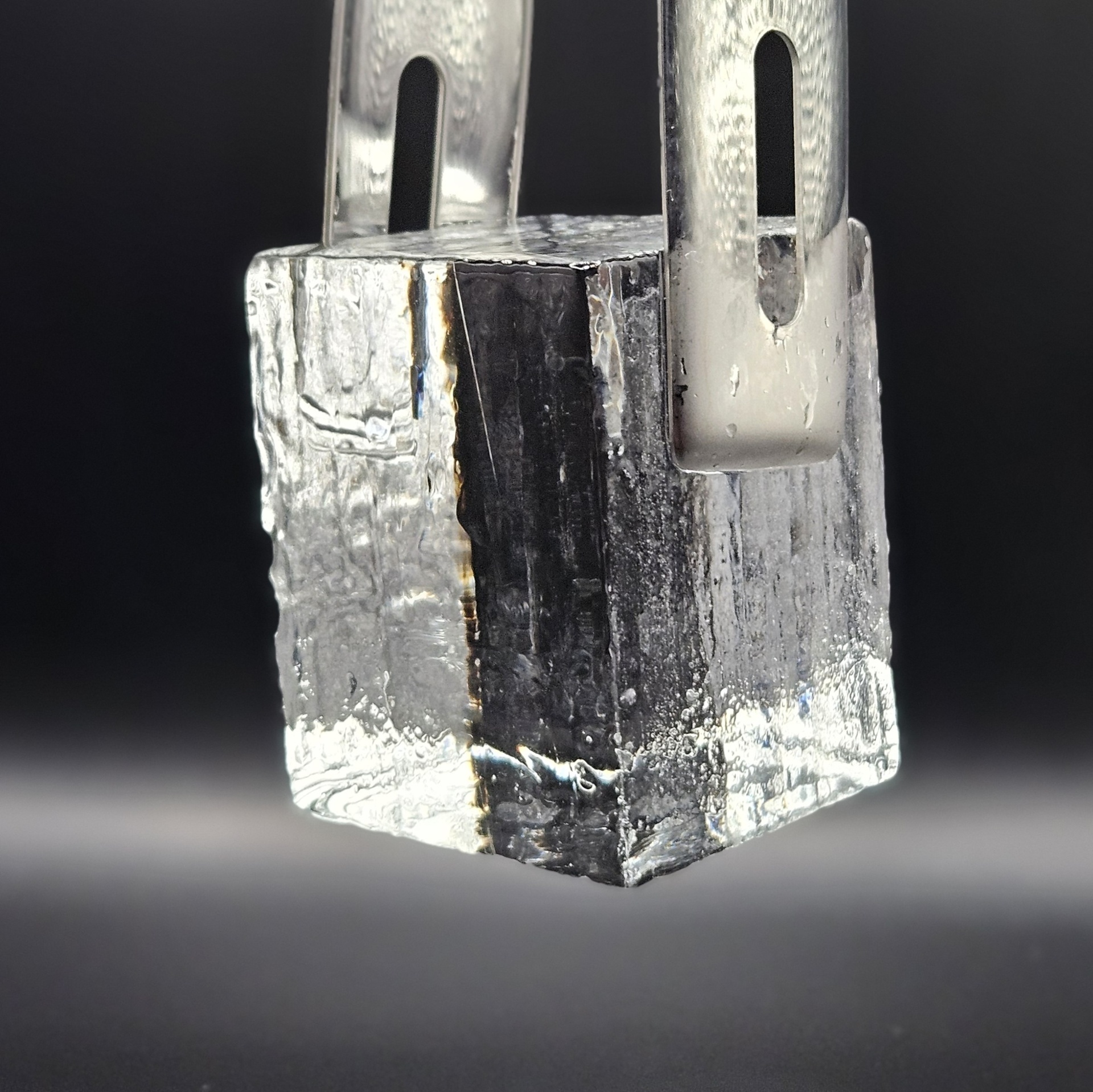 Wolfe and Kensington 2.5-inch clear ice cube held by metal tongs
